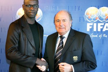 French football player Lilian Thuram (L) shakes hands with FIFA President Joseph Sepp Blatter in Zurich 16 March 2006. Football's world governing body FIFA said Thursday