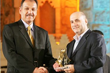 -REUTERS /Al Ansar Iraqi coach Adnan Hamad (L) receives his Best Coach award from Lebanese Parliament member Amin Sheri (R) during the Lebanese football awards night which