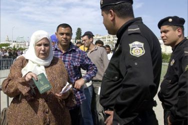 A Tunisian woman shows her passport to police 03 May 2006 while queuing to obtain tickets for the first three matches of the 2006 Football World Cup in Germany. Tunisia is in Group H with Spain, Ukraine and Saudi Arabia for the showpiece event that kicks off on June 9.