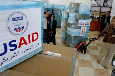 f_USAID employees are seen at the CARE international warehouse in the West Bank town of Ramallah, 10 May 2006,