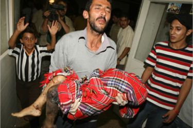 afp - A Palestinian man carries the body of six-year-old Palestinian girl Rawan Hajjaj into the Al-Shifa hospital in Gaza City, 08 July 2006