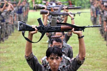 Members of the Maoist People Liberation Army carry arms during their daily exercise at Rajthali in Hedaunda, some 250 km (155 miles) south of Kathmandu, July 19, 2006. Pratap Memorial Brigade of the Maoist was displaying their show of strength to the media.