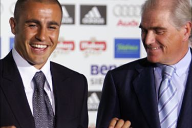 F_Italy's World Cup winning skipper Fabio Cannavaro (L) smiles by Real Madrid President Ramon Calderon as he is presented to the press after signing with Spanish football giants Real Madrid at the Santiago Bernabeu stadium