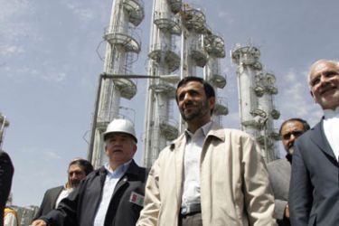 Iranian President Mahmoud Ahmadinejad (C) walks during the opening ceremony of a heavy water plant in Arak, 320 kms south of Tehran, 26 August 2006. Ahmadinejad