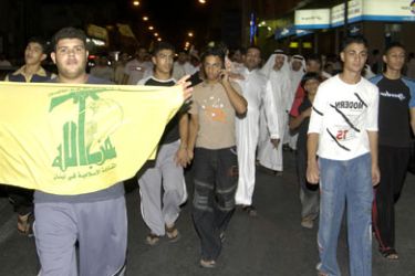 A demonstrator displays a Hezbollah flag during a protest in Dammam late 01 August 2006 to condemn the Israeli offensive against Lebanon. Eleven civilians were killed