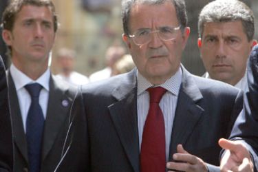 Italian Prime Minister Romano Prodi, accompanied by his bodyguards, walks in downtown Rome August 18, 2006. The Italian government formally approved