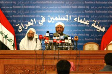 Head of public relations affairs in the Association of Muslim Scholars in Iraq Sheikh Abdel Salam al-Qubaissi (R) speaks during a joint press conference with the head