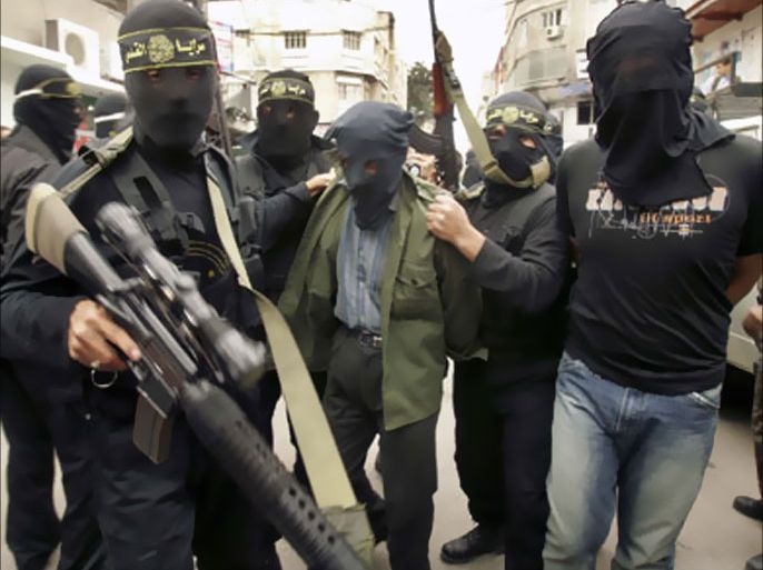 Islamic Jihad militants escort two Palestinian suspected collaborators with Israel (R and 3rd R) after they were arrested in northern Gaza Strip