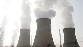 REUTERS/ A resident walks past a heat-engine plant in Datong county, northwestern China's Qinghai province, December 3, 2006. China's leaders recognise that tackling climate change is