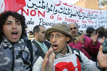 f_Moroccans shout slogans and hold a placard reading "No to price raise" during a demonstration organized by leftist parties against the high prices of consumer products and