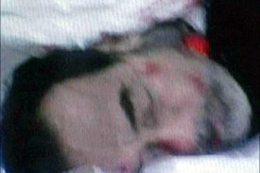 f_This grab taken from a video broadcast by Iraqi private network Biladi TV 30 December 2006 shows the dead body of former Iraqi leader Saddam Hussein draped in a white