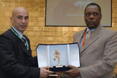 CAF (Confederation Africaine De Football) President Issa Hayatou (R) presents an award to Egyptian footballer Hossam Hassan during the CAF 28th General Assembly in the Sudanese capital in Khartoum, 11 February 2007.