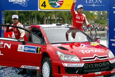 French driver Sebastian Loeb (R) and co-driver Daniel Elena from Monaco (Citroen C4) celebrate after winning the Mexican FIA World Rally Championship in Leon, 11 March 2007. AFP