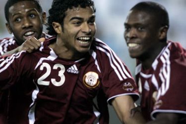 afp/Qatari Ali Hassan Afifi (C) celebrates after scoring against Bahrain during their 2008 Olympic Games qualifying match in Doha 18 April 2007. Qatar won 4-0. AFP PHOTO KARIM JAAFAR