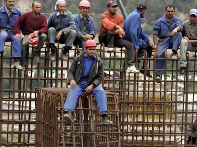 Workers sit on steel reinforcement during an official visit by Algeria's President Abdelaziz Bouteflika to the Western city of Blida May 28, 2007. REUTERS/Zohra Bensemra