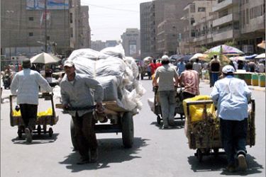 AFP/Iraqis use carts to transport their merchandise in Baghdad's Al-Shorjah market, 09 June 2007. Due to the numerous explosions that targeted the market,
