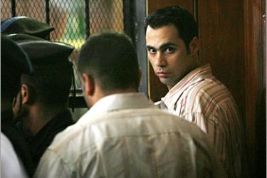 REUTERS/ Egyptian policeman Islam Nabeh is brought to court to face charges for torturing mini-bus driver, Emad el-Kabir, during his trial in Cairo June 7, 2007. El-Kabir's case gained