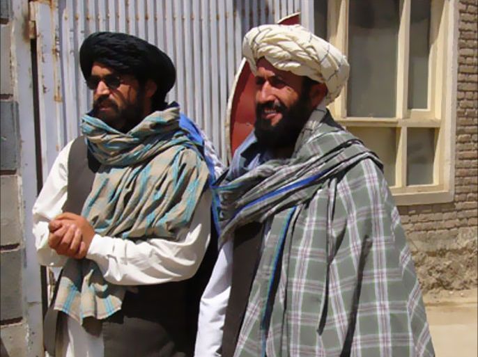 Taliban negotiators Qari Bashir (L) and Mawlavi Nasrullah exit the Afghan Red Crescent Society of Ghazni province to speak to the media August 11, 2007.
