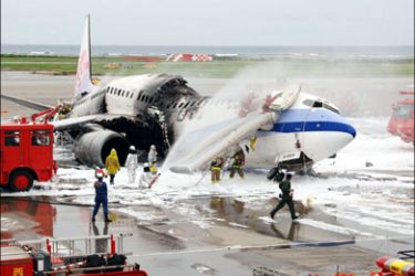 AFP : Fire fighters extinguish a fire on a Taiwan China Airlines Boeing 737, which was carrying 163 passengers and crew, after landing at the Naha Airport in Japan's outhern