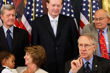 f_Democratic Senate Majority Leader Harry Reid (R-front) speaks shortly after signing legislation for the Children's Health Insurance Program (CHIP) at the US Capitol