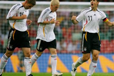 AFP/ Germany's Miroslav Klose (R) celebrates with teammates, Thomas Hitzlsperger (L) and Bastian Schweinsteiger after scoring the first goal of the match during their Euro 2008 Group D qualifying match against Wales at the Millenium Stadium in Cardiff, 08 September 2007.