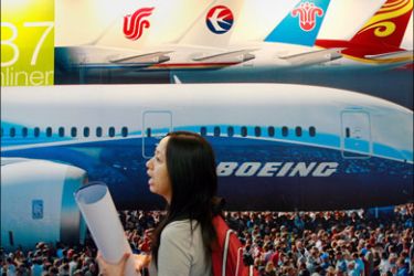 afp : A visitor walks past a Boeing's new 787 dreamliner aircraft poster on the opening day of the China Aviation Expo 2007 in central Beijing, 19 September 2007. China, the