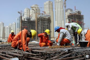 AFP/ Asian workers are seen working at a construction site in the Gulf emirate of Dubai, 05 September 2007. Hundreds of Asian labourers working in Dubai have been deported after thousands downed tools and staged an illegal strike at the weekend over poor wages and working conditions, reports said 29 October 2007.