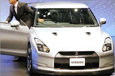 AFP / Japan's auto giant Nissan Motor's president Carlos Ghosn unveils the new "Skyline GT-R", equipped with twin-turbo charged 3.8-litter V6 engine, at a press preview of the 40th