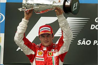 AFP/Finnish Formula One driver Kimi Raikkonen of Ferrari holds his trophy during the podium ceremony of Brazil's F1 GP