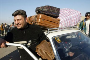 An Iraqi refugee takes get into a taxi upon his arrival from Syria to an international bus station in Baghdad's al-Likaa square, 28 November 2007.