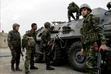 r/Turkish soldiers climb into their armoured personnel carrier (APC) as they patrol a road surrounded by rugged mountains in the southeastern Turkish province of Sirnak, bordering Iraq, November 7, 2007.