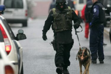 A policeman walks with a dog around the secondary Jokela school in Tuusula, some 60 kilometres north of Helsinki, 07 November 2007, where one person was killed and three