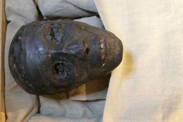 The mummy of the boy pharaoh King Tutankhamun is displayed for the first time in public in a special climate-controlled glass showcase after it was taken out of its sarcophagus in Luxor's Valley of the Kings