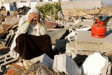 A Palestinian woman reacts over the rubble of her house after local witnesses said was demolished by an Israeli bulldozer in the southern Gaza Strip November 8, 2007.