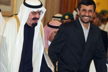 Iranian President Mahmoud Ahmadinejad (R) walks hand-in-hand with Saudi King Abdullah bin Abdul Aziz al-Saud as they arrive for the opening of the Gulf Cooperation Council (GCC) summit in Doha, 03 December 2007