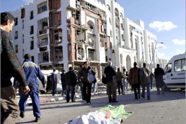 REUTERS/ The body of a bomb blast victim is covered outside the constitutional court building in Algiers December 11, 2007. Suspected Al Qaeda militants detonated twin car bombs in Algiers on Tuesday, killing up to 67 people in the bloodiest attack in the north African country since an undeclared civil war in the 1990s. REUTERS/Stringer (ALGERIA)