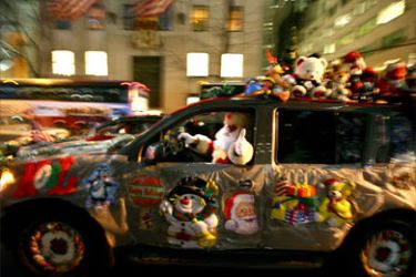 A man dressed as Santa Claus drives along New York's 5th Avenue in his decorated SUV 21 December 2007.