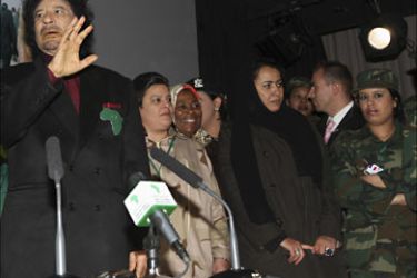 r_Libyan leader Muammar Gaddafi (front L), accompanied by his female bodyguards (R), attends a meeting with female personalities in Paris
