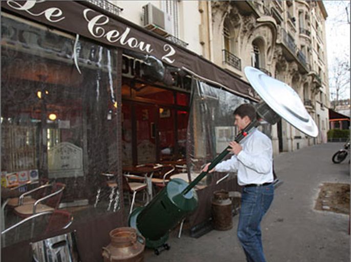 AFP A man installs a heater on a Paris cafe terrace where people can smoke, 08 January 2008, after cafes, restaurants and nightclubs across France
