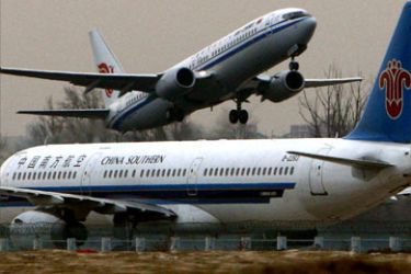An Air China airlines plane takes off behind a China Southern airlines plane at Beijing airport January 11, 2008