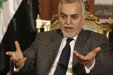 r - Iraqi Vice President Tareq al-Hashemi gestures as he speaks during an interview with Reuters in Baghdad January 31, 2008. Picture taken January 31, 2008