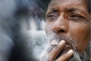 REUTERS/A man smokes a leaf cigarette called "bidi" on a pavement in the northeastern Indian city of Siliguri February 13, 2008. Smoking is killing