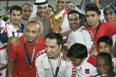 r - Kuwait Club players and fans pose after winning the Crown Prince Cup final soccer match against Qadsia in Kuwait City March 3, 2008. REUTERS/Tariq AlAli