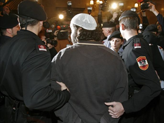 A muslim couple (2nd L and R) are escorted by police as they arrive in court for their trial in Vienna March 3, 2008. The couple, named only as Mohamed M.,