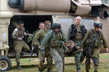 AFP Israeli soldiers evacuate a wounded comrade from a helicopter after landing at the Soroka Hospital airfield in the southern Israeli town