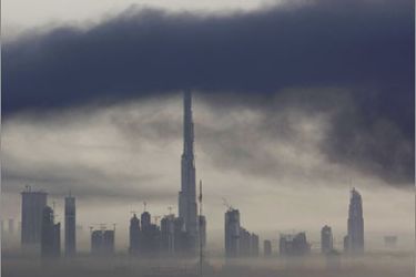 REUTERS/Smoke from an explosion at a fireworks warehouse rises over an industrial area in Dubai, near the Burj Dubai, the world's tallest tower