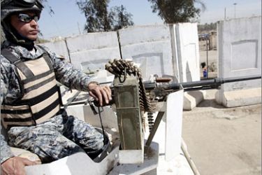 AFPAn Iraqi police commando guards a position in front of a concrete blocks wall surrounding an area in Baghdad on March 6, 2008. Five years