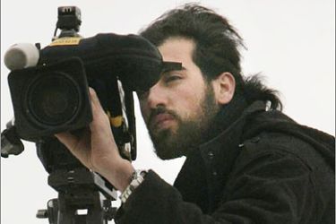 REUTERS/Reuters cameraman Fadel Shana films in Rafah camp in the southern Gaza Strip in this February 4, 2008 file photo. A Reuters cameraman was killed