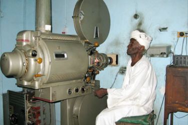 An elderly Sudanese man sits by a film projector at the Nyala cinema in southern Darfur on June 11, 2008