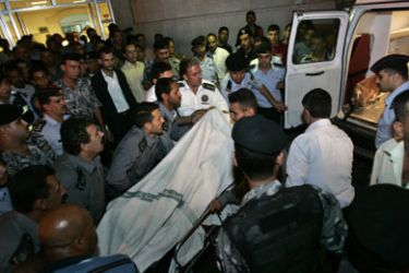 Paramedics transport a victim into a hospital in Amman, after a gunman shot and wounded six Lebanese people near the Roman amphitheatre, July 16, 2008. An unidentified gunman